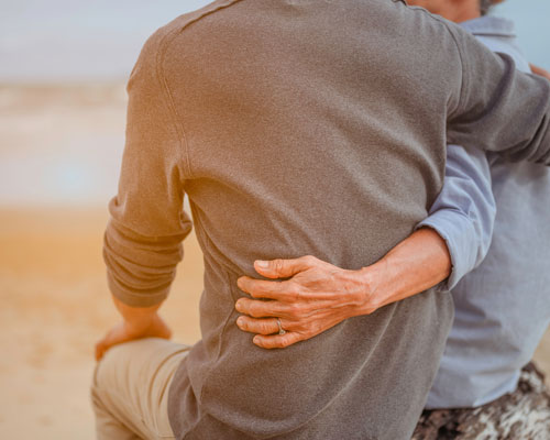 Elderly couple sitting on beach