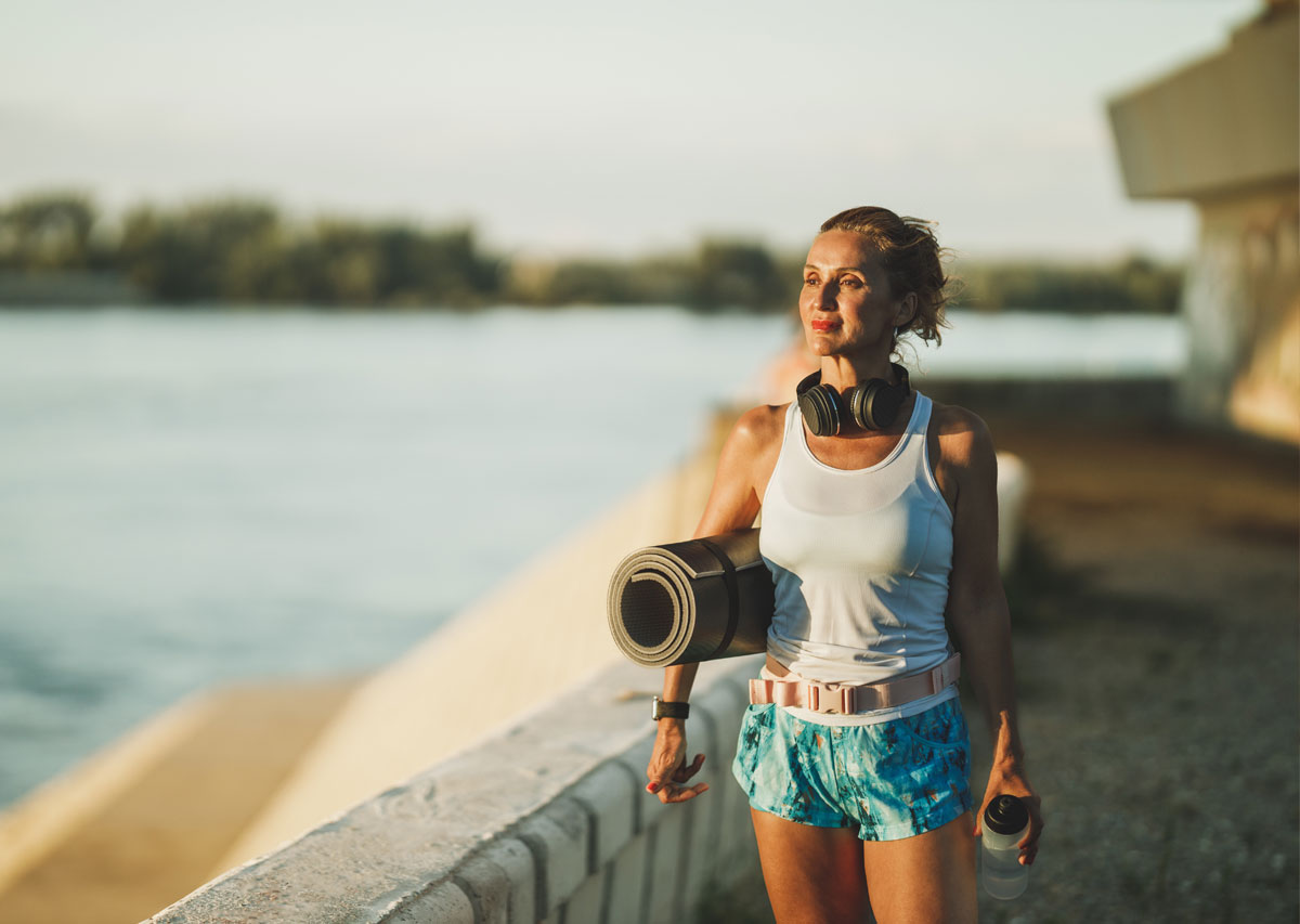Woman With Rolled Up Mat